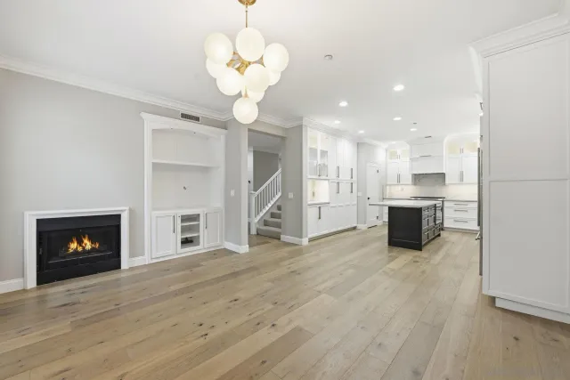 a view of a kitchen with a stove wooden cabinets and a fireplace