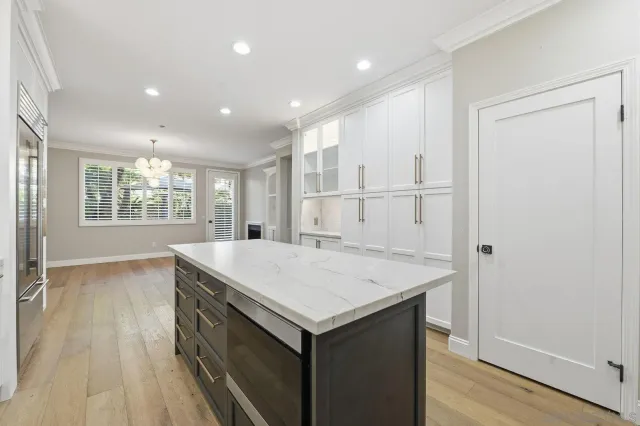 a kitchen with a wooden floor and window