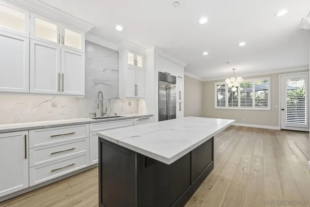 a kitchen with a wooden floor and window