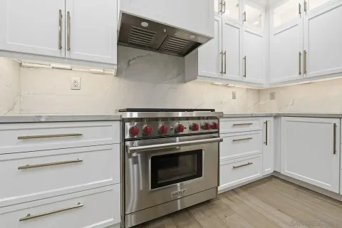 a stove top oven sitting inside of a kitchen
