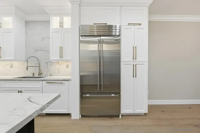 a kitchen with a refrigerator and a sink