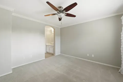 an empty room with closet and windows