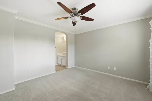 an empty room with closet and windows