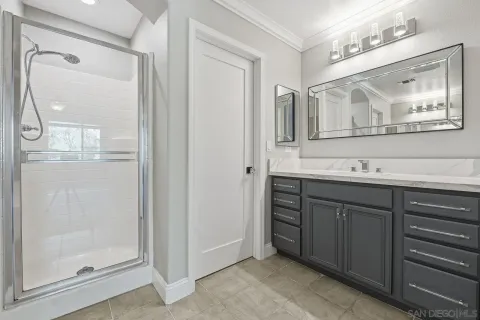 a bathroom with a double vanity sink and a mirror