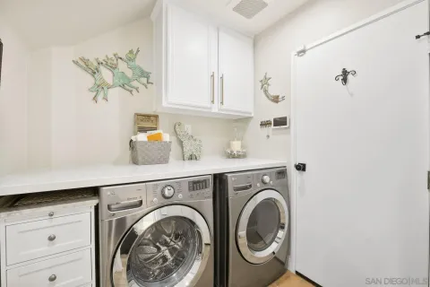 a utility room with sink dryer and washer