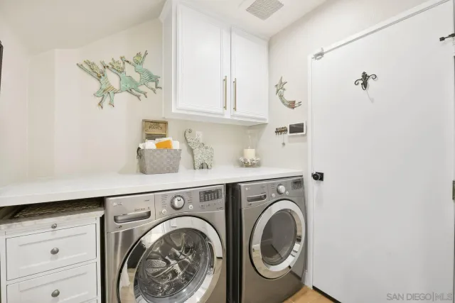 a utility room with sink dryer and washer