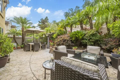 a view of a patio with table and chairs and potted plants
