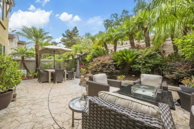 a view of a patio with table and chairs and potted plants