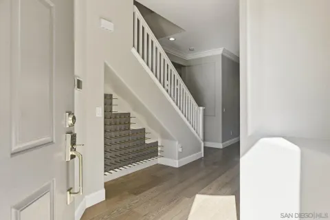 a view of entryway and hall with wooden floor