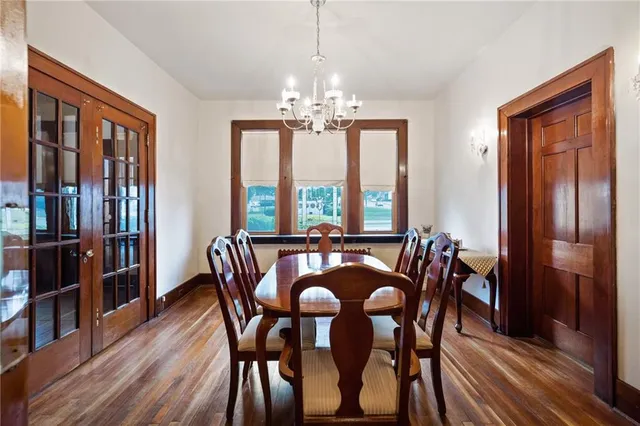 a dining room with furniture window and wooden floor