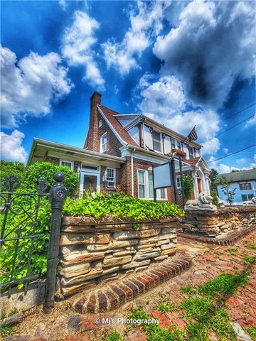 a front view of a house with a garden