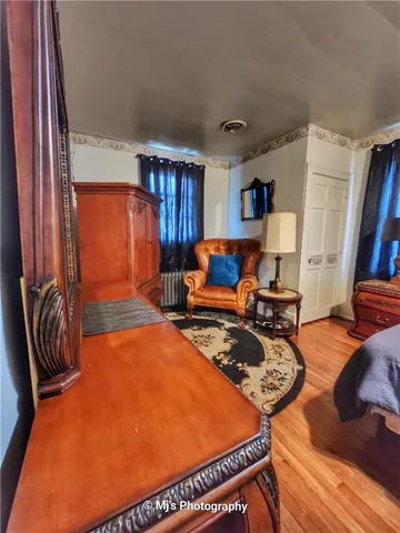 a room with furniture pool table and a flat screen tv