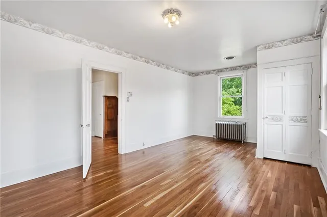 a view of a livingroom with wooden floor and window