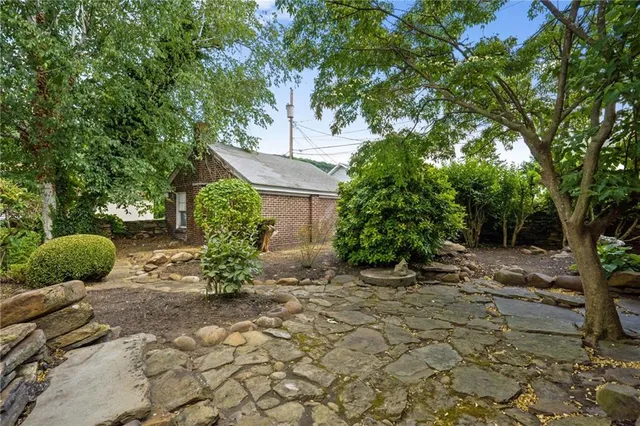 a view of a chair and table in backyard