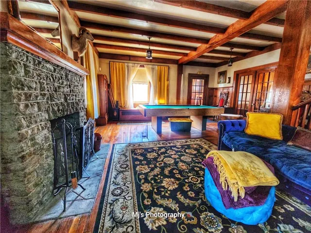 wooden floor with furniture and a fireplace