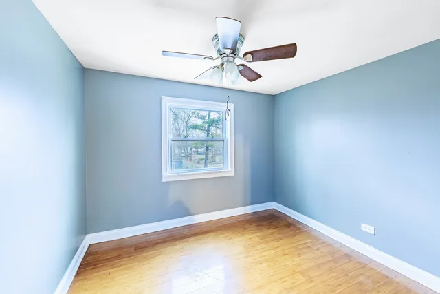 a view of a room with window and ceiling fan