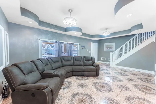 a living room with furniture and a ceiling fan