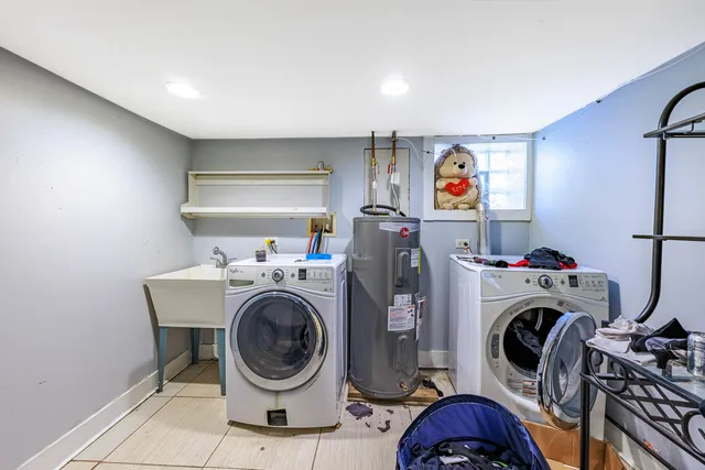 a utility room with dryer washer and a view of bedroom