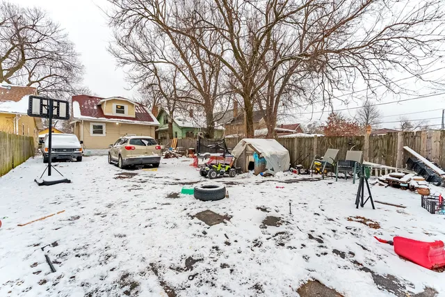 a view of a backyard with a white bed and a chairs