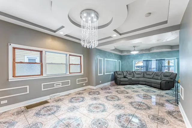 a large bedroom with a large bed and a chandelier