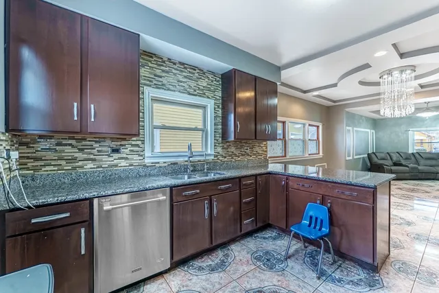 a kitchen with stainless steel appliances granite countertop a sink and cabinets