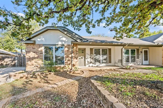 a front view of a house with a garden and patio