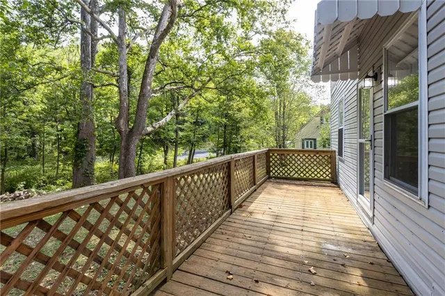 a view of balcony with wooden floor and outdoor seating