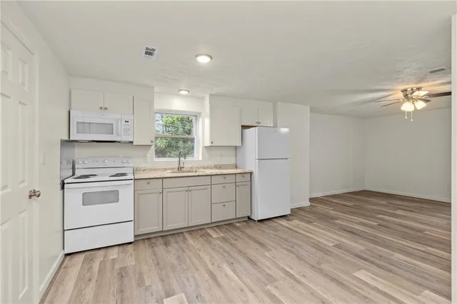 a kitchen with a white cabinets and white appliances