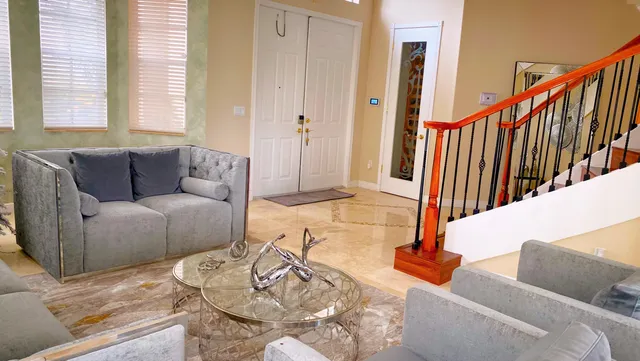 a living room with furniture and a book shelf