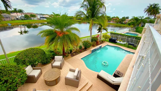 a view of a backyard and swimming pool
