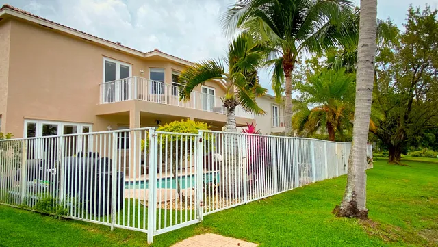 a view of swimming pool with a garden and patio
