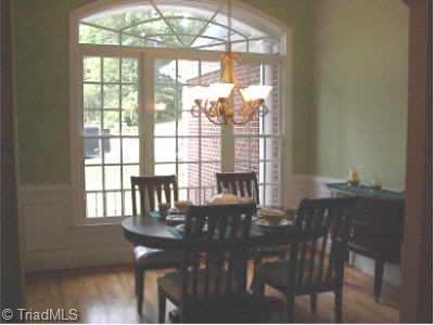 Other. 953 Rivers Edge Drive; Open Formal Dining Room with high ceilings, arched openings, detailed moldings, arched window, and hardwood floors.
