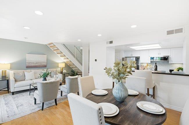1031 Colonel Way Half Moon Bay, CA 94019 - Photo 12 of 52 a living room with furniture and a dining table with wooden floor