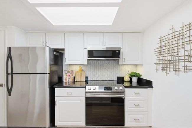 1031 Colonel Way Half Moon Bay, CA 94019 - Photo 15 of 52 a kitchen with stainless steel appliances white cabinets and a refrigerator