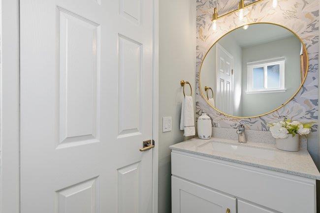 1031 Colonel Way Half Moon Bay, CA 94019 - Photo 18 of 52 a bathroom with a sink vanity and mirror
