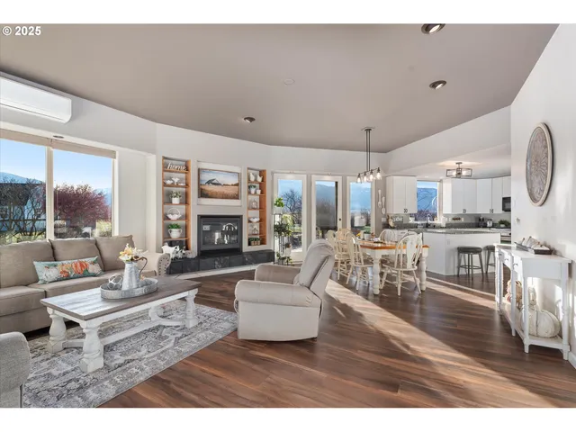 a living room with fireplace furniture and a large window