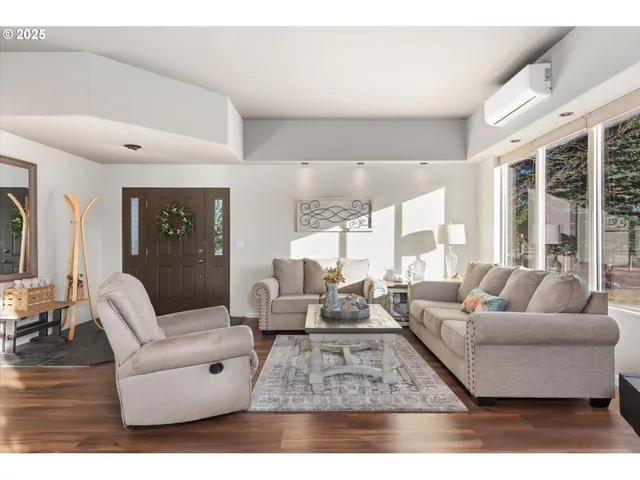 a living room with furniture dining table and a large window