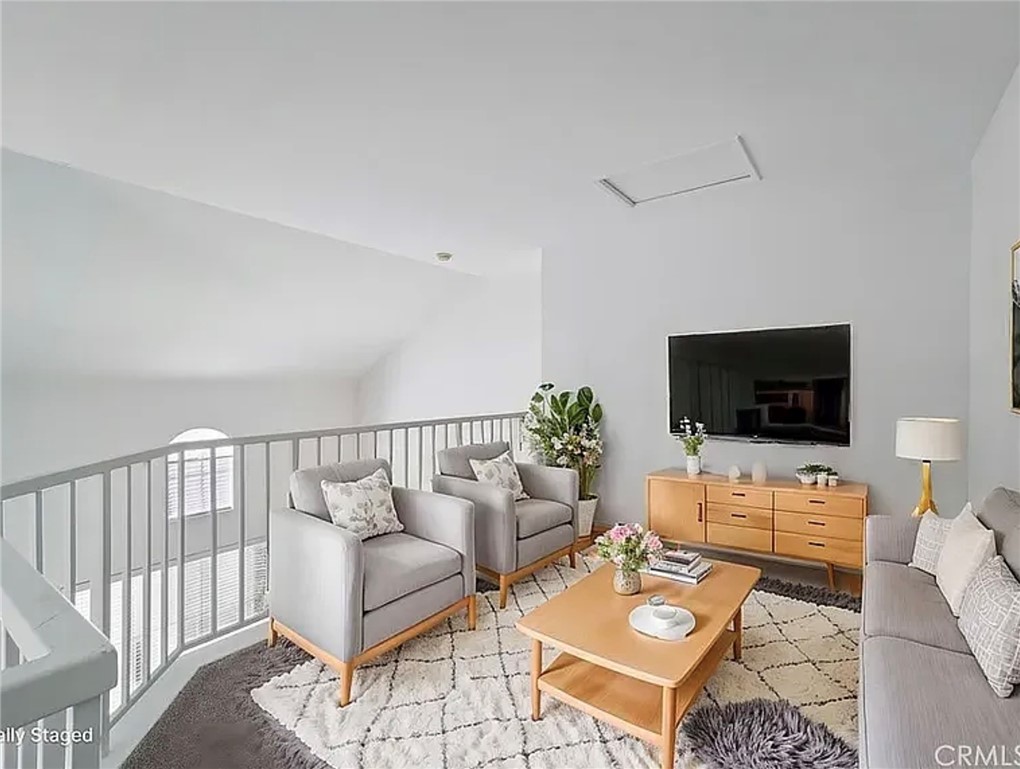 20000 Plum Canyon Road, Unit 225 Saugus, CA 91350 - Photo 7 of 12 a living room with furniture and a flat screen tv