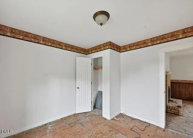 a view of a room with wooden floor