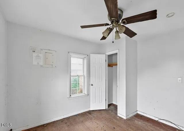 a view of a livingroom with a ceiling fan and window
