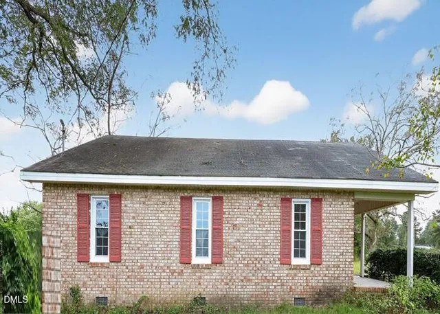 a front view of a house with a yard and outdoor seating
