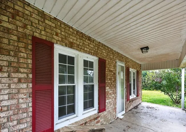 a front view of a building with a garden