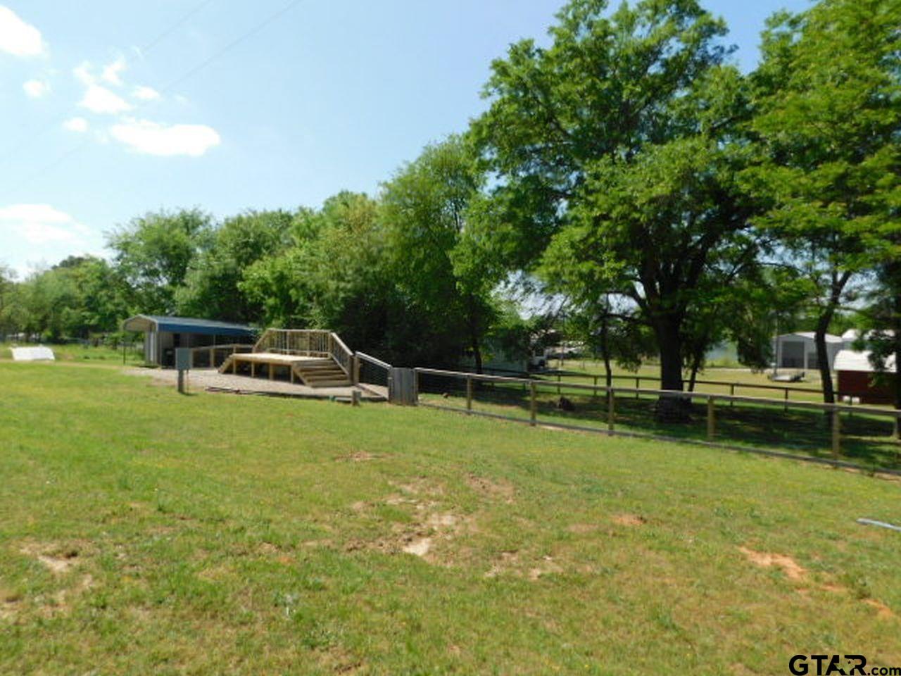 285 Caddo Quitman, TX 75783 - Photo 11 of 14 a front view of a house with swimming pool and trees