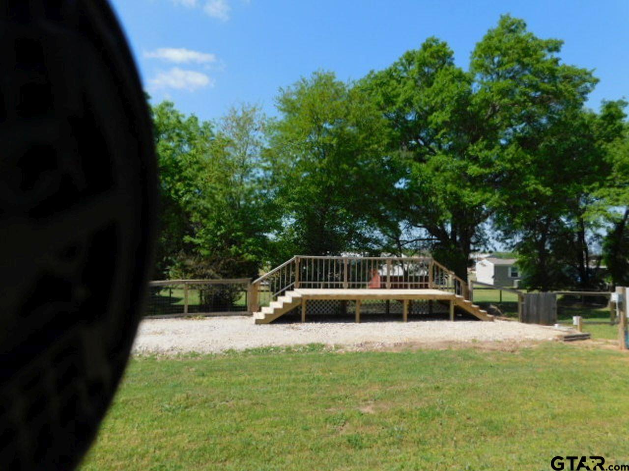 285 Caddo Quitman, TX 75783 - Photo 9 of 14 a view of yard with swimming pool and trees in the background