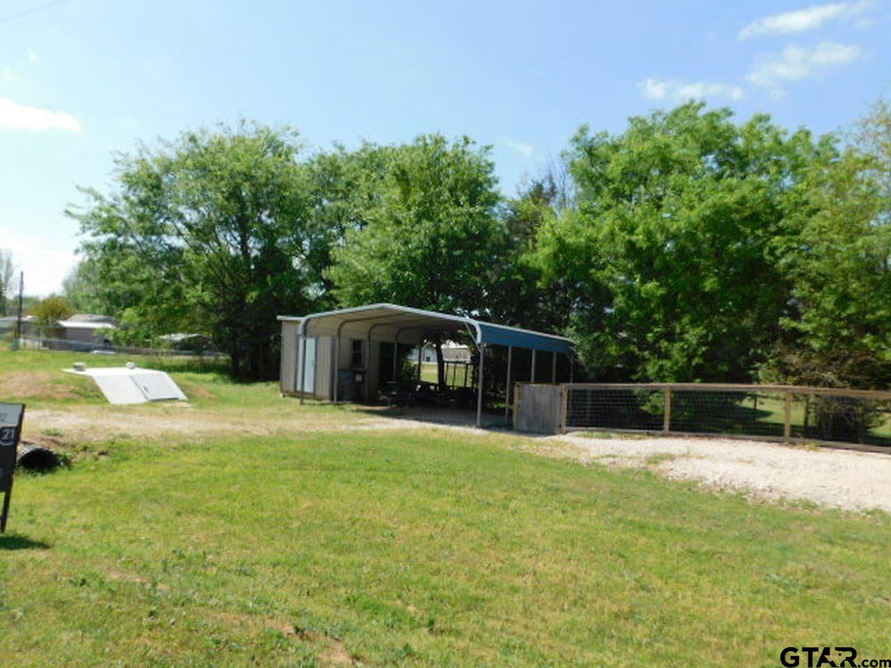 285 Caddo Quitman, TX 75783 - Photo 10 of 14 a swimming pool is sitting in the middle of the green field