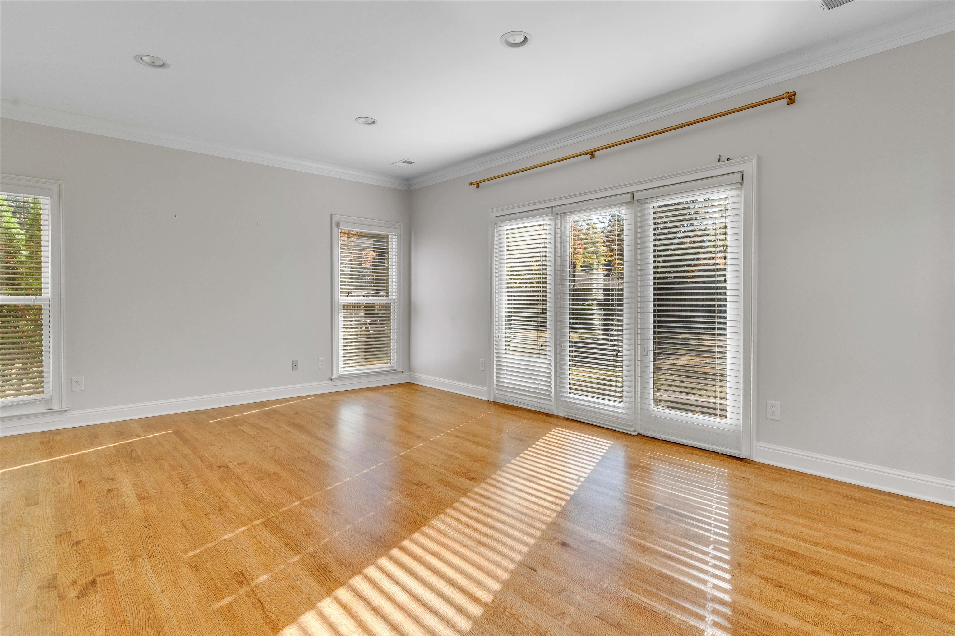 2014 Heather Cove Memphis, TN 38119 - Photo 17 of 40 a view of an empty room with wooden floor and a window