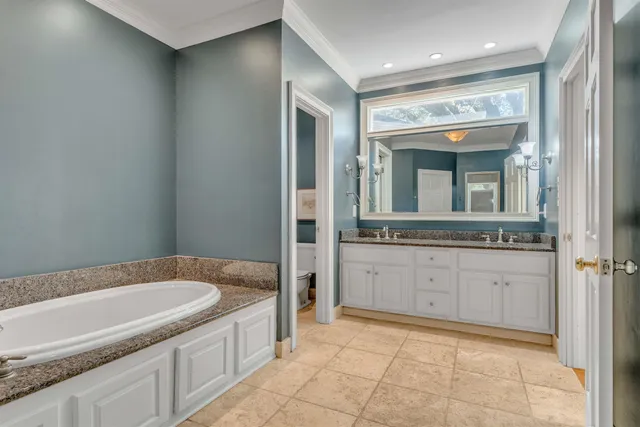 a bathroom with a granite countertop sink and mirror