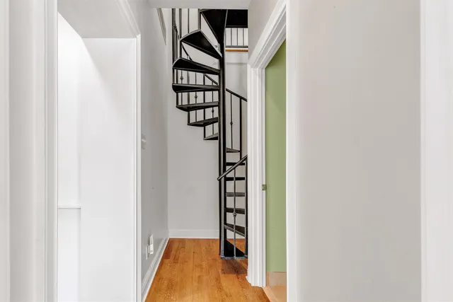 a view of a hallway with wooden floor and entryway