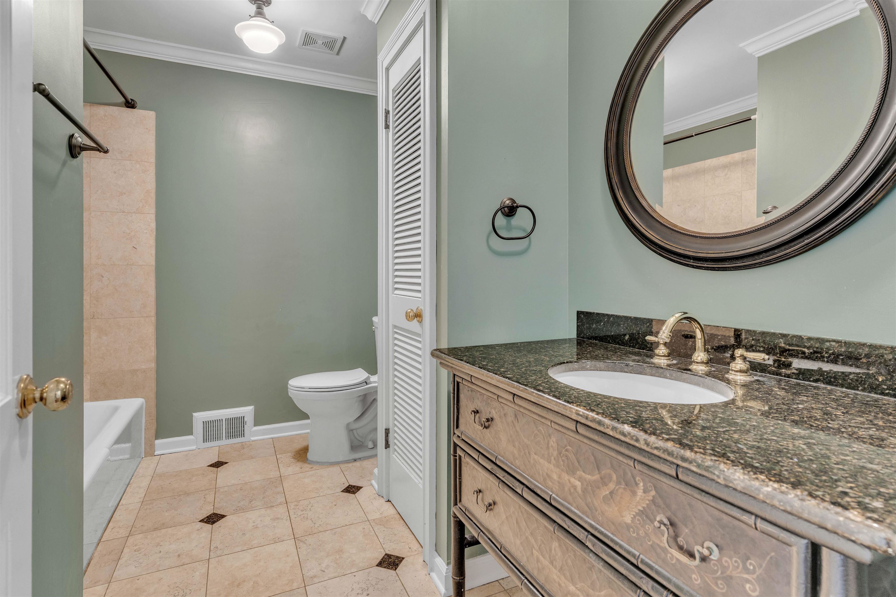 2014 Heather Cove Memphis, TN 38119 - Photo 25 of 40 a bathroom with a granite countertop toilet a sink and a mirror