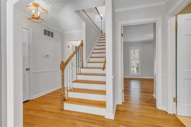 a view of entryway and hall with wooden floor